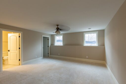 Woodview bedroom with carpet and ceiling fan