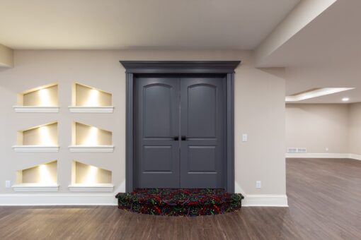Woodview lower-level arched double doors with lit niches