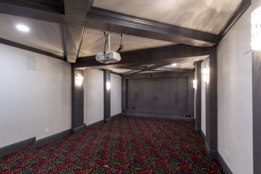 Woodview home theater with projector and dark wood columns