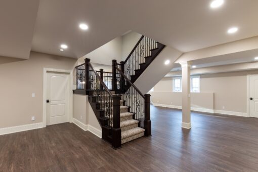 Woodview lower-level staircase with iron balusters