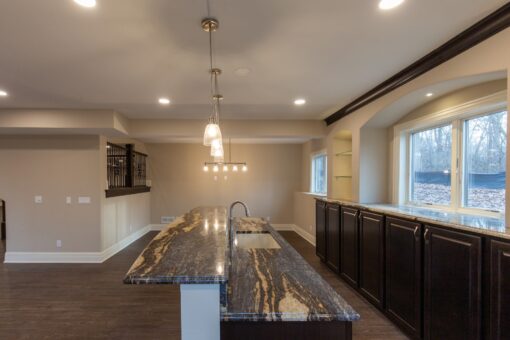 Woodview lower-level bar with granite island
