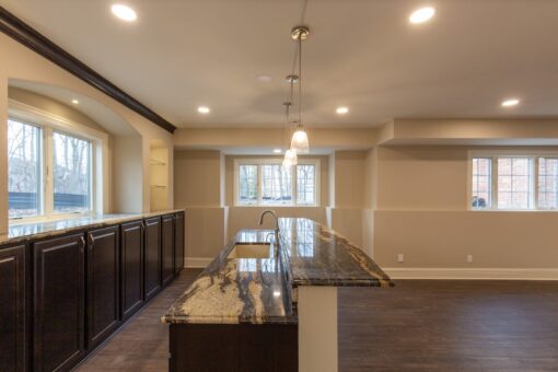 Woodview lower-level bar and family room with windows