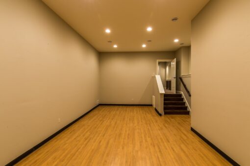 Kingfogl custom home open home gym with wood floor and stairs