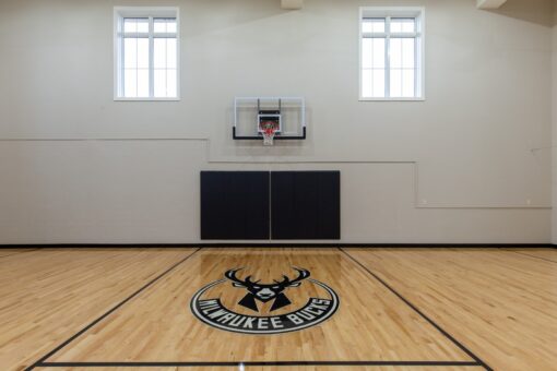 Vizzini indoor basketball court with logo at center court