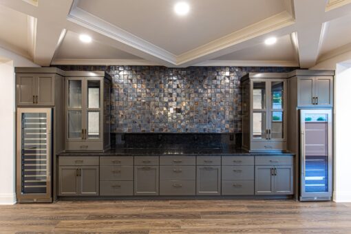 Carlisle lower-level bar with mosaic backsplash and gray cabinetry