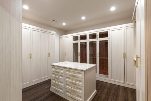 Carlisle lower-level dressing room with white built-ins and island