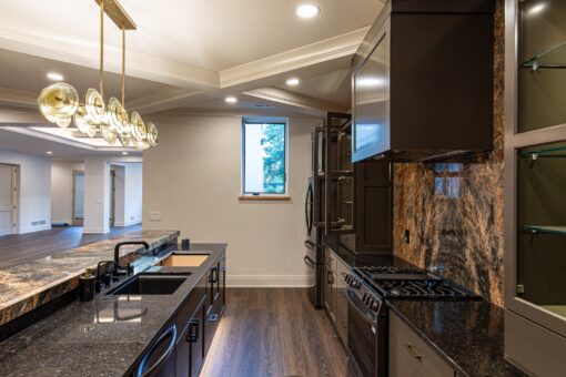 Carlisle lower-level kitchen with dark cabinetry and range