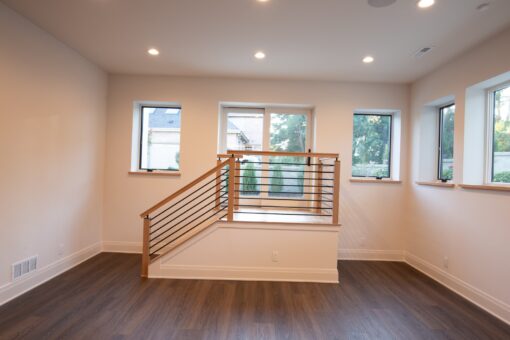 Carlisle lower-level staircase with wood railing