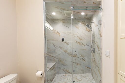 Carlisle glass shower with marble tile