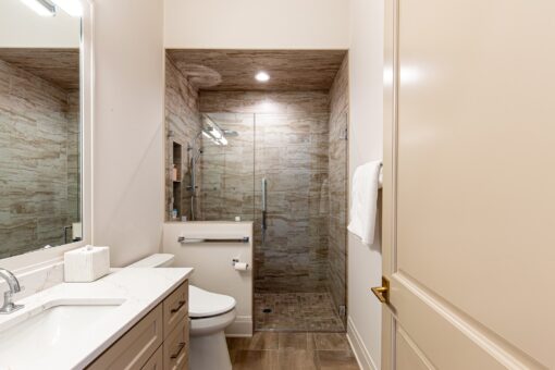 Carlisle walk-in shower with stone tile