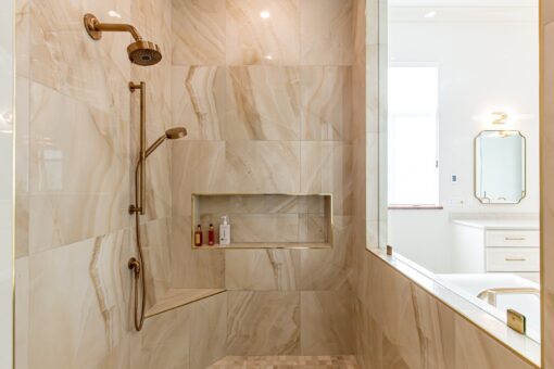 Carlisle marble shower with niche and brass fixtures