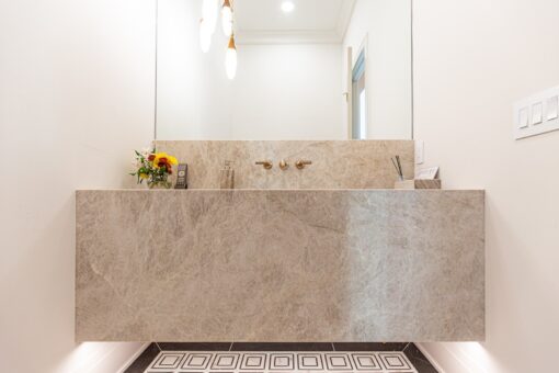 Carlisle powder room with stone sink wall
