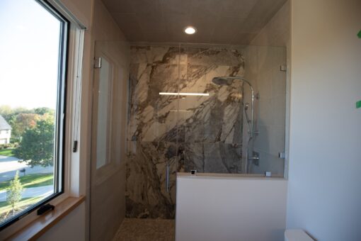 Carlisle marble shower with glass enclosure