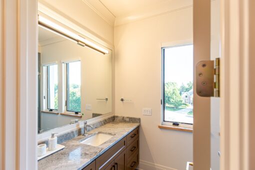 Carlisle bathroom with granite vanity and window