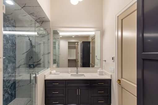 Carlisle bathroom with dark vanity and mirror