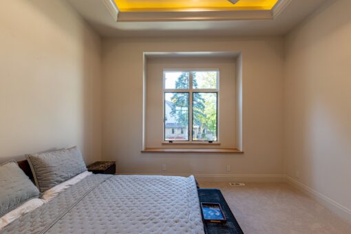 Carlisle bedroom with lit tray ceiling and window