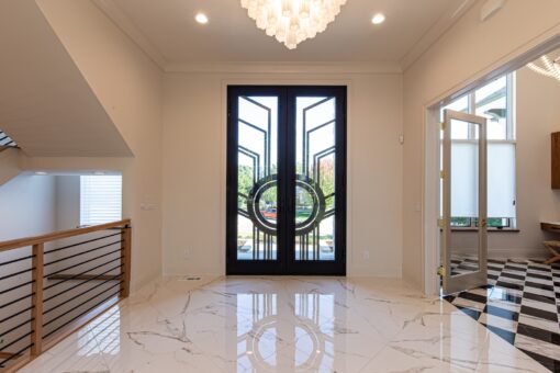 Carlisle modern iron and glass entry doors and chandelier