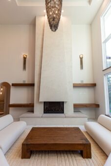 Carlisle great room fireplace with tall plaster chimney