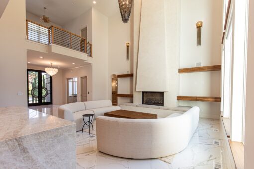 Carlisle great room with plaster fireplace and floating shelves
