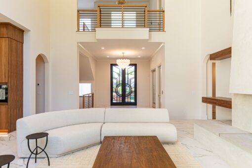Carlisle great room with curved sofa and view to the entry