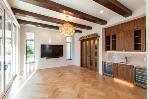 Carlisle hearth room with timber beams, chandelier and media wall