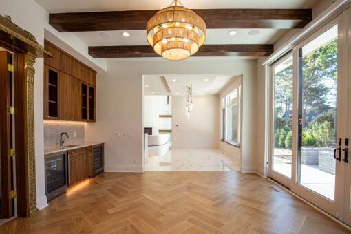 Carlisle hearth room with chandelier and herringbone floor
