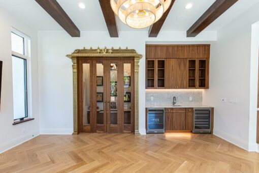 Carlisle hearth room with carved wood door and wet bar