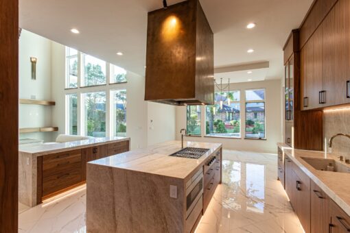 Carlisle kitchen with walnut island and brass range hood
