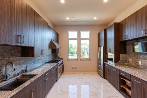 Carlisle kitchen with walnut cabinetry and window