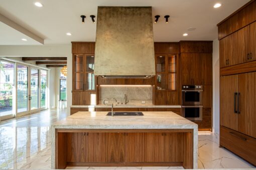 Carlisle kitchen island with marble top and brass hood