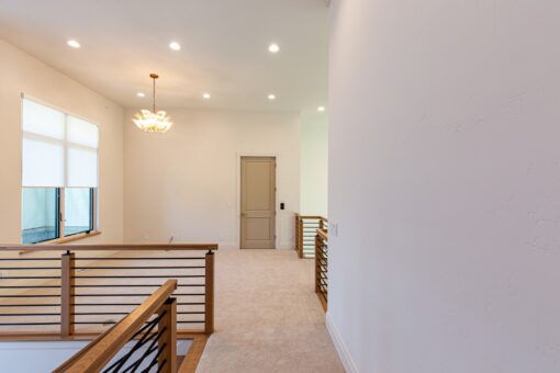 Carlisle upper hallway with railing and chandelier