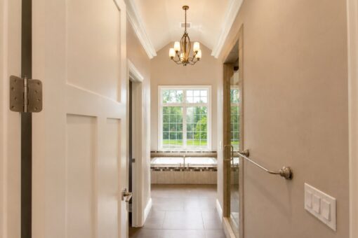 Auburn custom home in Brookfield by Kingfogl – 1st floor - primary bath - hallway to tub