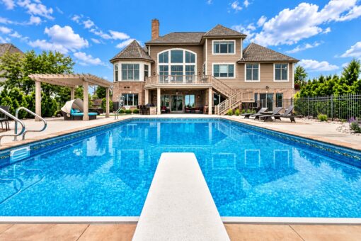 Bradon custom home in Brookfield by Kingfogl – rear elevation with pool, diving board and pergola