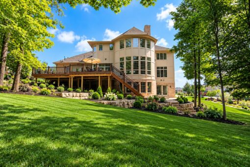 Brandywine custom home in Brookfield by Kingfogl – rear elevation with elevated deck and mature trees