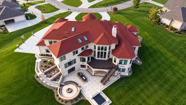 Callista custom home in Brookfield by Kingfogl – aerial rear view with curved stone patio