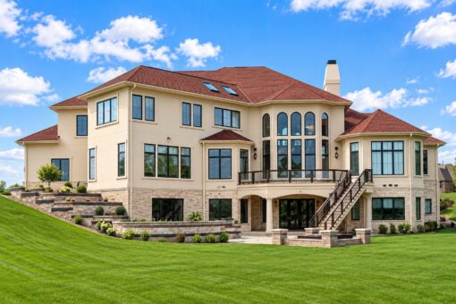 Callista custom home in Brookfield by Kingfogl – rear elevation with balconies and stone terraces