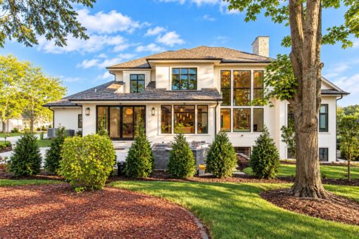 Carlisle custom home in Brookfield by Kingfogl – rear elevation with walls of glass and covered patio