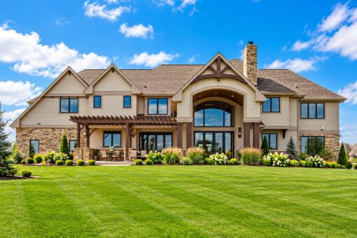 Compton custom home in Brookfield by Kingfogl – rear elevation with stone accents and covered patio