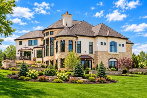 Haven custom home in Brookfield by Kingfogl – rear elevation with turret and landscaped yard