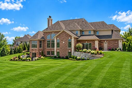 Nottingham custom home in Delafield by Kingfogl – rear elevation with brick exterior and stone retaining wall