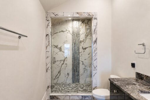 Prescott custom home in Mequon by Kingfogl – bath dark marble shower