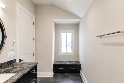 Prescott custom home in Mequon by Kingfogl – bath dark marble window seat