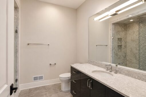 Prescott custom home in Mequon by Kingfogl – bath patterned tile vanity