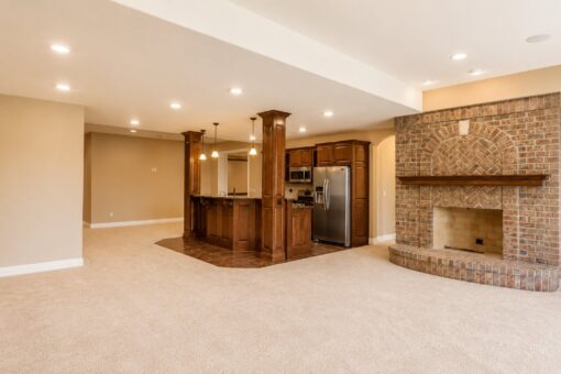 Richland custom home in Brookfield by Kingfogl – basement - bar and fireplace