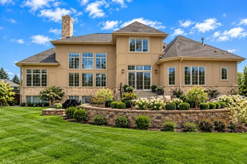 Ridgeview custom home in Brookfield by Kingfogl – rear elevation with stone retaining walls