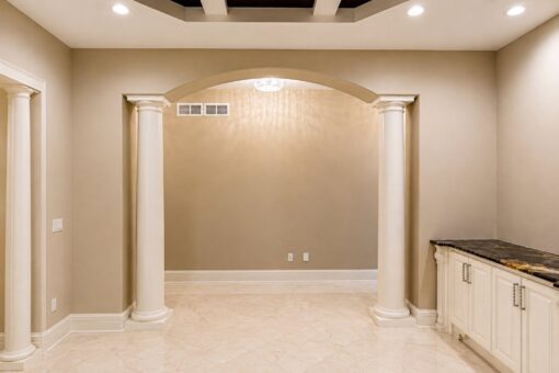 Saddlebrook custom home in Mequon by Kingfogl – dining room archway and built-ins