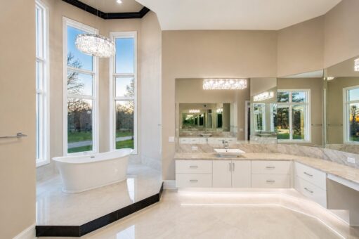 Saddlebrook custom home in Mequon by Kingfogl – primary bathroom tub and vanity dusk
