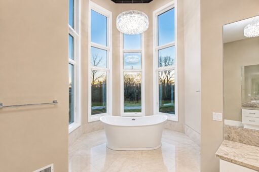 Saddlebrook custom home in Mequon by Kingfogl – primary bathroom tub dusk