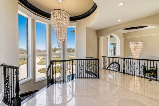 Saddlebrook custom home in Mequon by Kingfogl – 2nd floor hallway overlook and chandelier