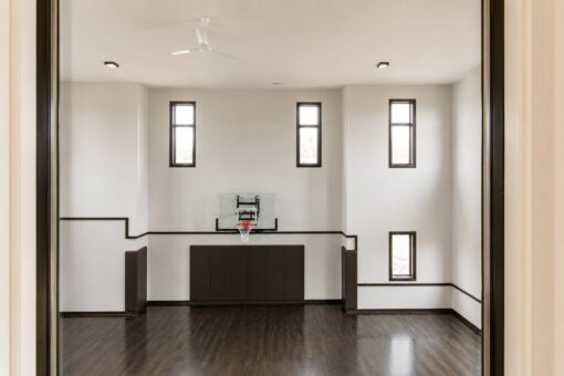 Saddlebrook custom home in Mequon by Kingfogl – basement basketball court through doors